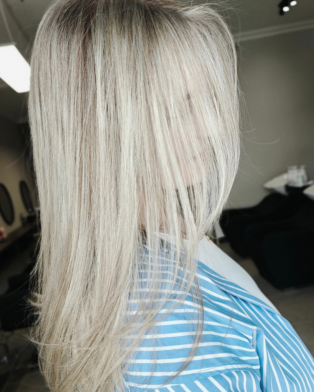 Bright platinum blonde balayage with a sleek finish by Cafuné Hair Lounge